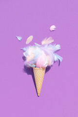 A captivating fusion of nature and sweetness: a feather delicately poised a top an ice cream cone,...