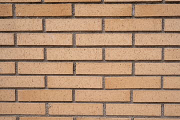Background wall of yellow bricks closeup.