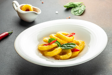 fried squid rings breaded on a dark background. banner, menu, recipe place for text, top view