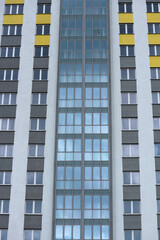 City background. Windows of an apartment building. Vertical photo.