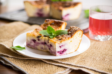 cooked cottage cheese casserole with berry filling in a plate