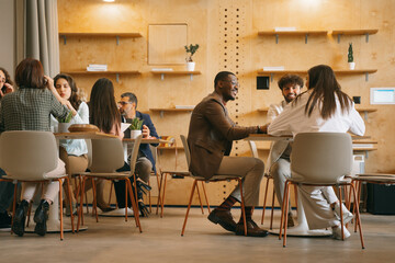 Inter-generational, multicultural group of creative people starting up new business project. They...