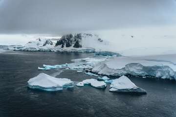 Mountain panorama of Antarctica shoreline. Amazing panoramic view. The pieces of the ice floating...