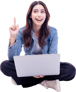 Young woman sitting on floor legs crossed using laptop computer on white background Smiling student teen girl working on laptop computer Full body of young girl netbook point finger to empty space