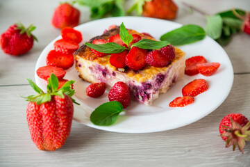 cooked cottage cheese casserole with berry and strawberry filling in a plate