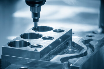 The CNC milling machine chamfer cutting mold base part by chamfer tool in the light blue scene.