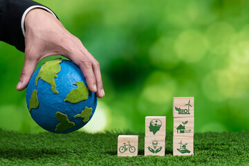 Hand of businessman holding Earth, symbolizing green business utilizing biofuel technology and...