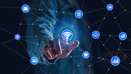 Smart business IOT, internet of things concept. Businessman touching IOT icon on virtual screen, connected internet network to access AI intelligence, business analytics, internet investing.