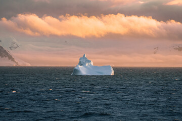 Beautiful iceberg floating in the water. Photo taken at sunset in Antarctica and Arctic Greenland....