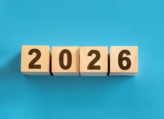 2026 displayed on wooden letter blocks isolated on pastel blue background