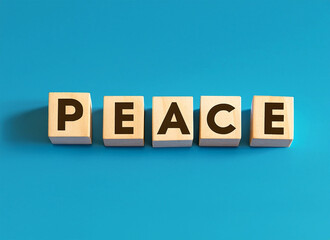 Peace displayed on wooden letter blocks on pastel blue background.