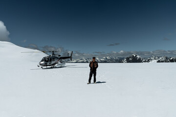 Fototapeta na wymiar Helicopter snow Landing in new Zealand. Tourist enjoying ride. Franz Josef Glacier snow landing, New Zealand