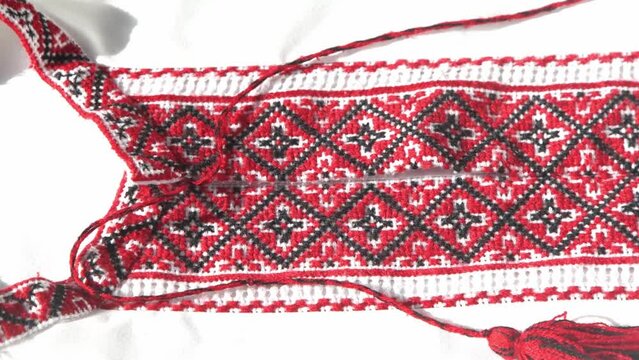 Ukrainian clothes embroidered shirt. Red and black threads background. Vyshyvanka is a symbol of Ukraine. Embroidery cross stitching. National Ukrainian stitch. Traditional clothing symbol.