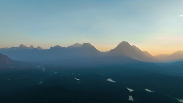 Mountains and rocks during sunset. High rocky mountains. Banff National Park, Alberta, Canada. Aerial view. Drone flight over the mountains. Landscape during sunset. 
