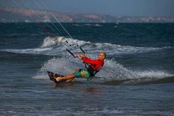 Kitesurfing on the waves of the sea in Mui Ne beach, Phan Thiet, Binh Thuan, Vietnam. Kitesurfing,...