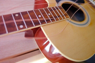 close-up wooden part of the instrument, changing strings on acoustic guitar, strings hanging...