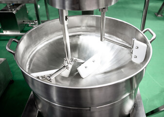 Blender machine large barrel mixing food ingredient.