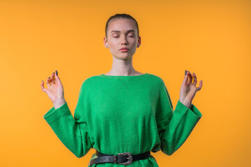Calm woman relaxing, meditating, refuses stress. Pretty girl breathes deeply