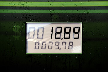 screen with 12,89 dollars fuel price increase due to inflation, gasoline price counter on display showing gas price on digital display, gas refueling counter in liters and amount in euro liters