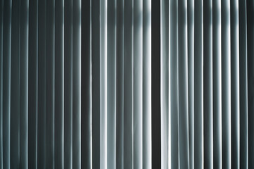 striped curtain with a light coming through it