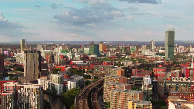 manchester city central downtown seen through an open window aerial view drone flying out from inside the room over castlefield area