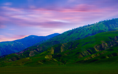 Fototapeta premium Side View on Country Road with mountain at sunset in California, USA