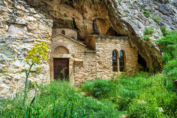 Orthodox monastery enclosed by Davelis cave in Penteli, a mountain to the north of Athens, Greece