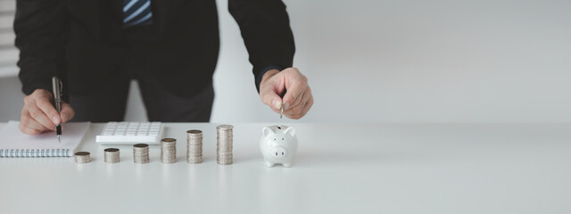Person with pile of coins and piggy bank, money saving concept for future use and financial...