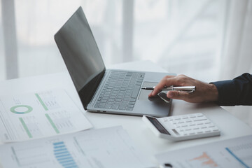 Businessman in a private office at his company and is reviewing company financial documents, senior management checking financial information for accuracy. Financial management.