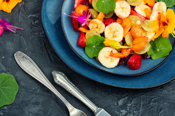 Juicy fruit salad with nasturtium.