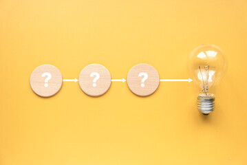Creative thinking idea, innovation and inspiration concept. Bulb with question mark diagram on yellow background.