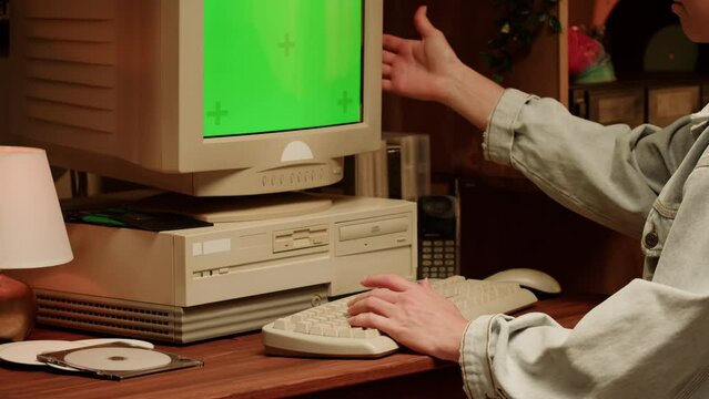 Retro PC with croma key green screen, Using vintage old computer. Dvd player, disc drive. Music recorder, playing retro computer games. 