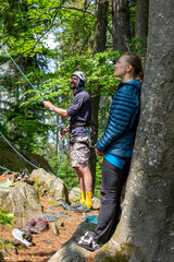 Risk and Determination: Hiking and climbing together in a forest: casual outdoor adventure with friends