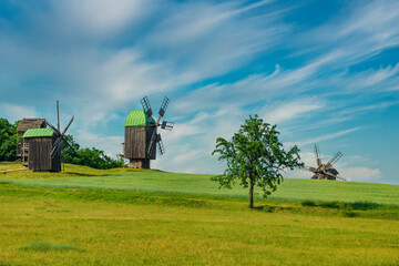 Fototapeta premium Idyllic countryside view with wind mills