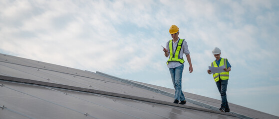 Service engineer checking solar cell on the roof for maintenance if there is a damaged part....