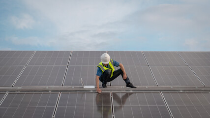 Service engineer checking solar cell on the roof for maintenance if there is a damaged part....