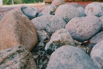 Rounded sea stones as a blind area around the cottage. Background. smooth stones on the shore
