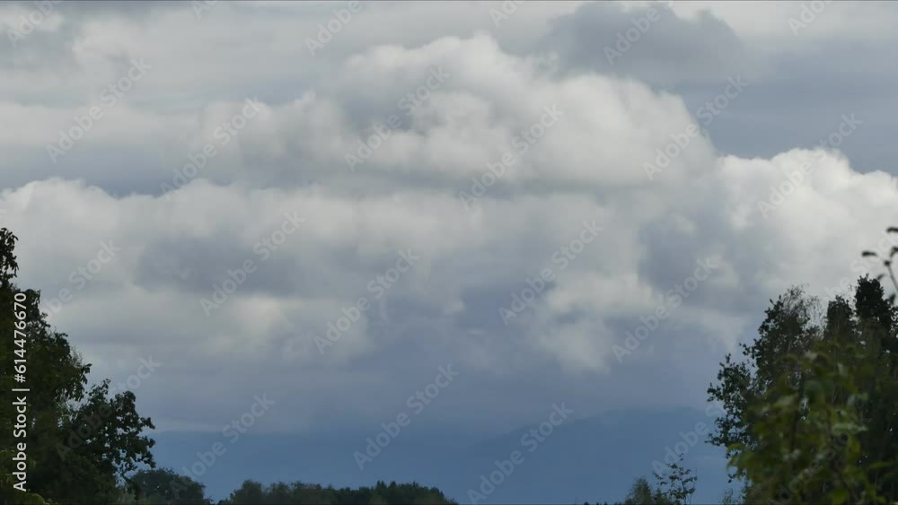 Poster time lapse - landscape with horizon of mountains and sky with dynamic and fast moving clouds. view w