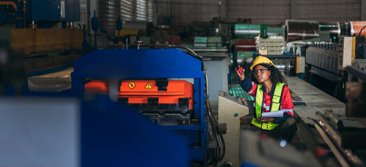 Industrial worker inspecting and check up machine at factory machines.Technician working in metal sheet at industry. Foreman checking Material or Machine.