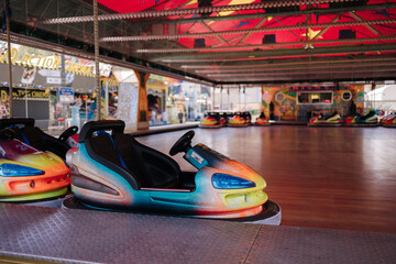 Bumper car at fun fair. Colorful electric cars in amusement park
