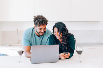 couple surfing the internet making digital credit card purchases in the web