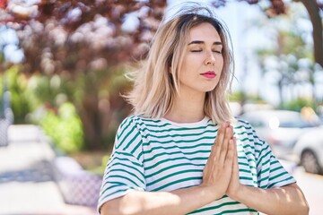 Young woman doing yoga exercise at park