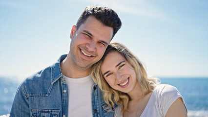 Fototapeta premium Man and woman couple smiling confident standing together at seaside