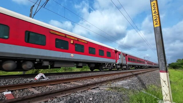 Passenger Train hauled by a WAP7 loco heads towards Pune, at Uruli near Pune India.