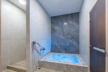 A small pool after visiting the sauna in the SPA. The room is decorated with tiles in soothing...