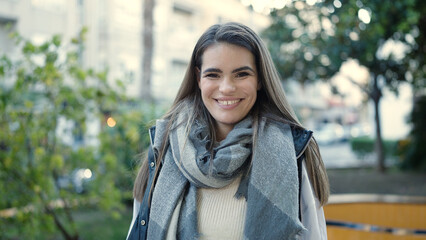 Young beautiful hispanic woman smiling confident at street