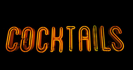 Yellow neon cocktails sign on black background