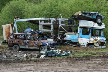Car dump. Various vehicles in ruined condition.