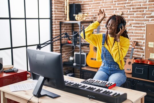 African american woman musician having dj session at music studio