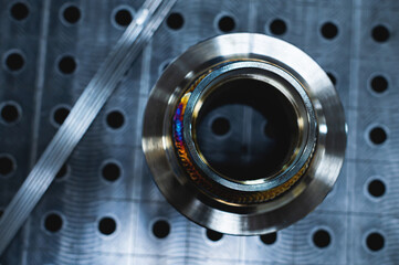 Freshly welded seam on a stainless flange. Production of metal products from stainless steel by...